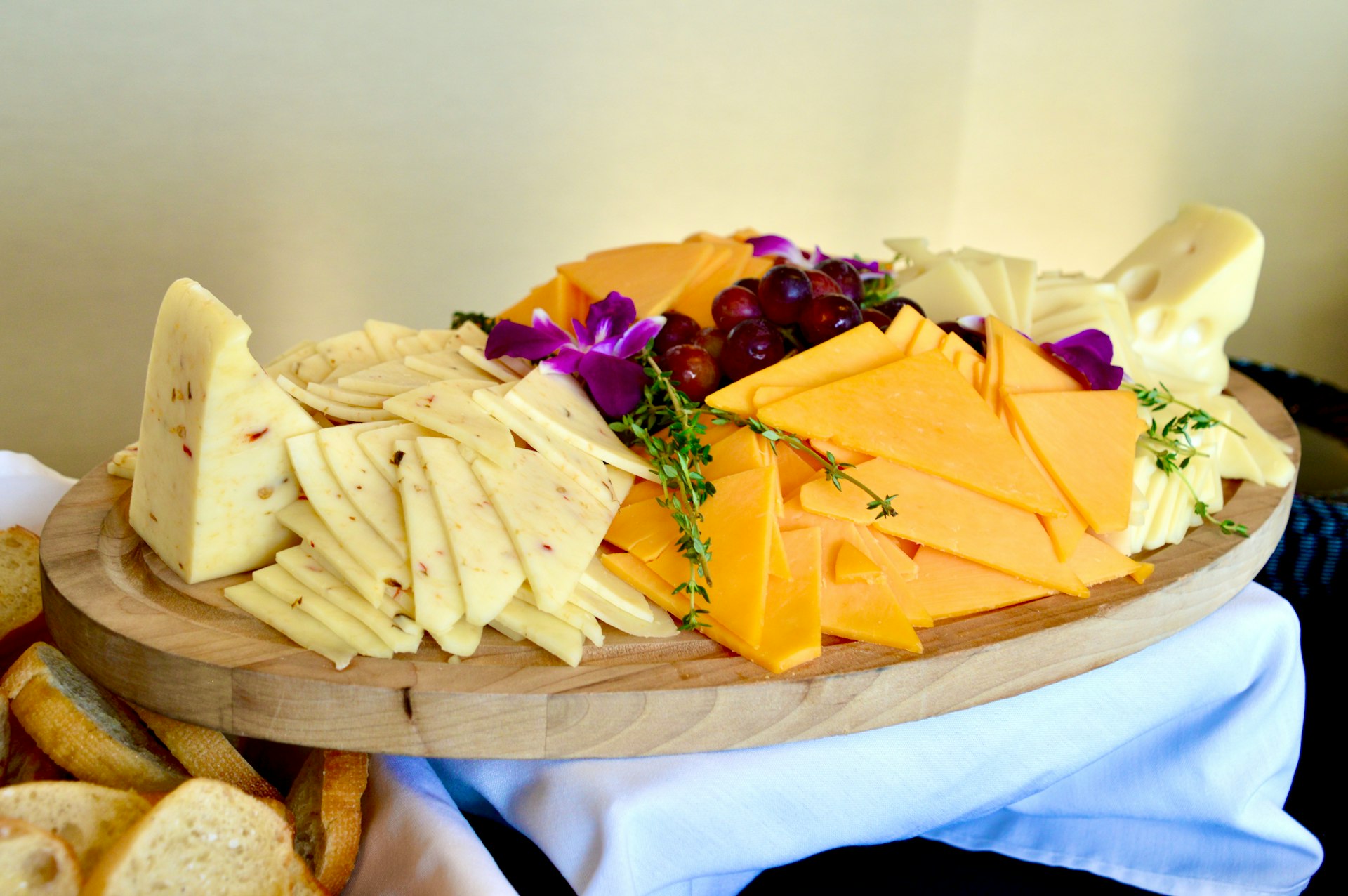 Freeze dried cheese sliced cheese on brown wooden chopping board